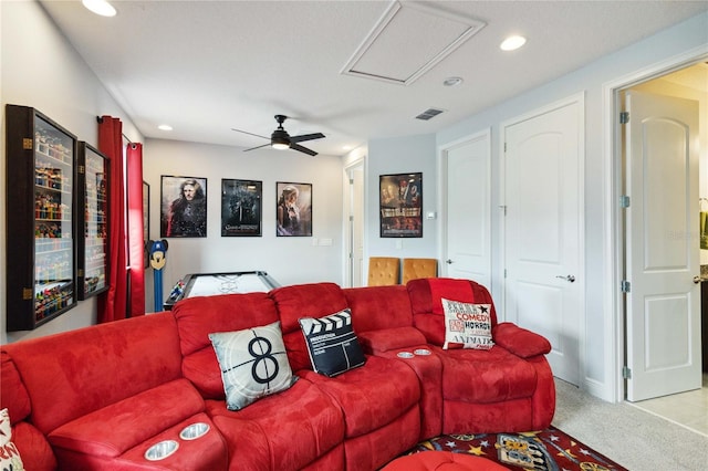 carpeted living room with ceiling fan