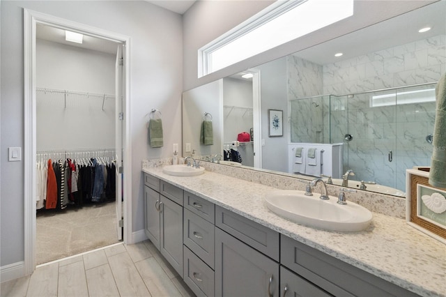 bathroom with vanity and a shower with door