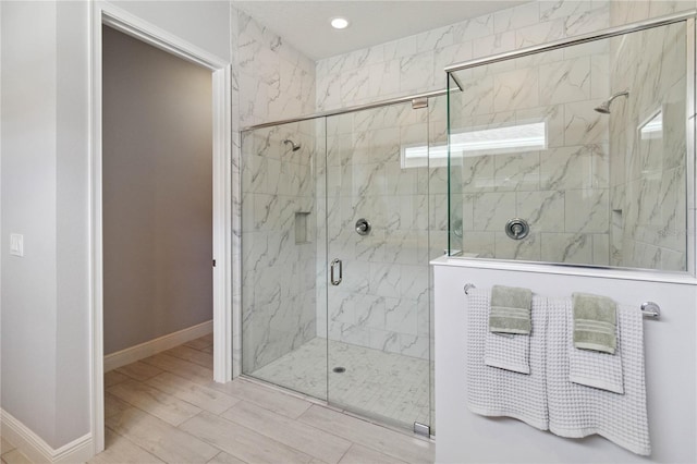 bathroom featuring walk in shower and hardwood / wood-style flooring