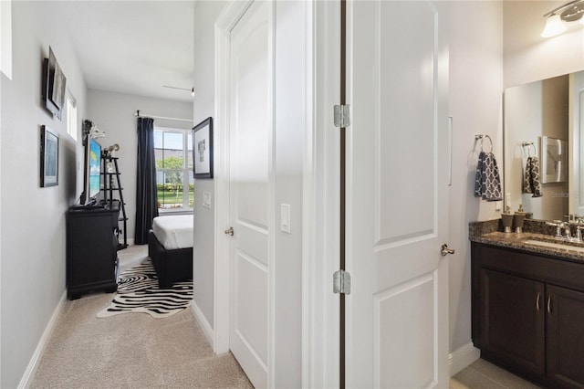 5075 Twin Lakes Blvd, Saint Cloud, FL 34772 - hall with a sink, light carpet, and baseboards
