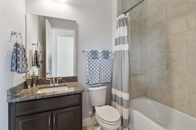 full bathroom with vanity, shower / bath combo with shower curtain, and toilet