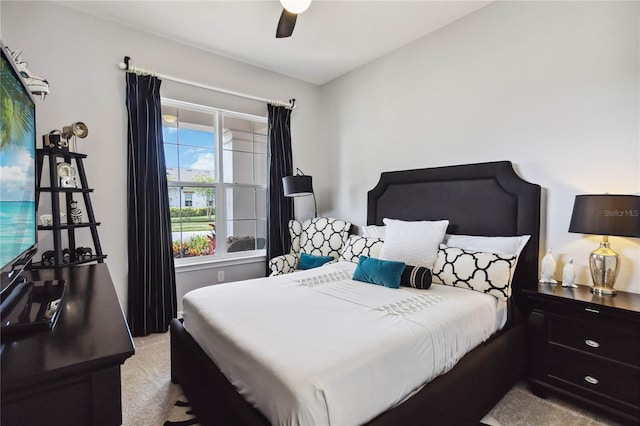 bedroom with ceiling fan and light colored carpet