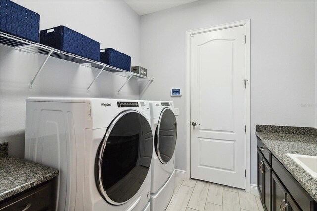 5075 Twin Lakes Blvd, Saint Cloud, FL 34772 - laundry room with washer and clothes dryer and baseboards