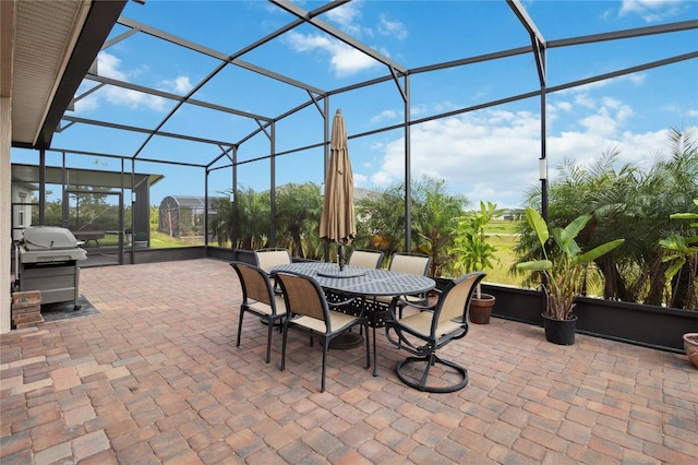 view of patio featuring grilling area and a lanai