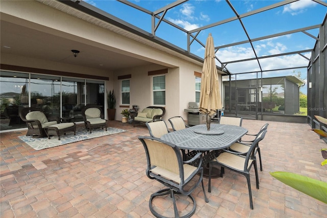 view of patio / terrace with grilling area, a lanai, and an outdoor hangout area