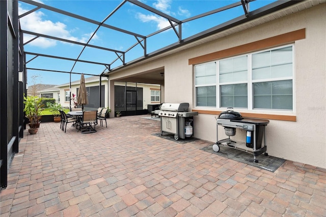 view of patio / terrace with area for grilling and glass enclosure