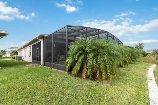 5075 Twin Lakes Blvd, Saint Cloud, FL 34772 - view of green lawn featuring central air condition unit and a lanai