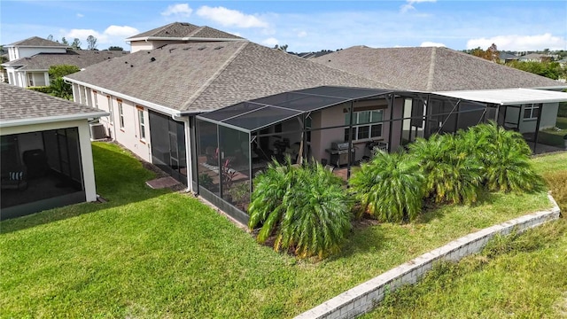 rear view of property featuring a lanai and a yard