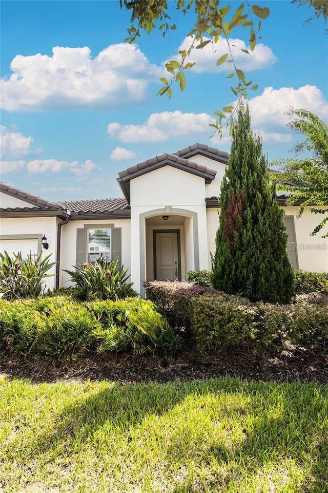 7845 Wandering Way, Orlando, FL 32836 - ranch-style house featuring a garage, a tile roof, and stucco siding