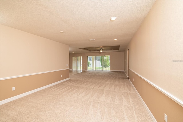 unfurnished room featuring ceiling fan, a textured ceiling, and carpet floors