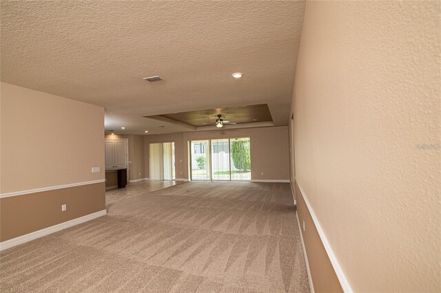 7845 Wandering Way, Orlando, FL 32836 - empty room with light colored carpet, a textured ceiling, a ceiling fan, baseboards, and recessed lighting