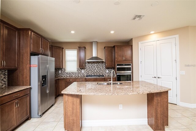 7845 Wandering Way, Orlando, FL 32836 - kitchen with stainless steel appliances, wall chimney exhaust hood, a sink, a center island with sink, and tasteful backsplash