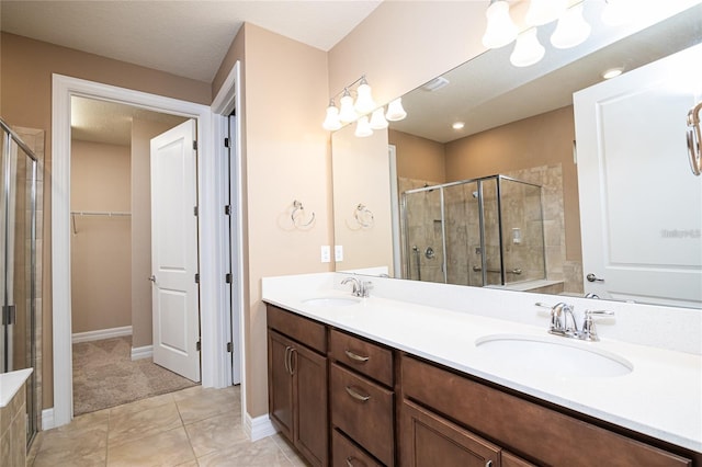 bathroom featuring vanity, walk in shower, tile patterned floors, and a textured ceiling