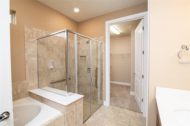 bathroom with tile patterned flooring, plus walk in shower, and a textured ceiling