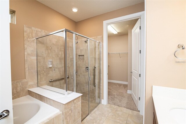 7845 Wandering Way, Orlando, FL 32836 - full bathroom featuring a stall shower, a bath, vanity, and a walk in closet