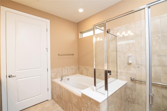 bathroom with shower with separate bathtub, a textured ceiling, and tile patterned flooring