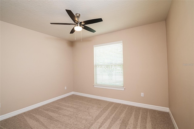 carpeted empty room featuring a textured ceiling and ceiling fan