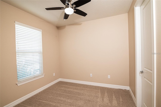 spare room featuring a textured ceiling, ceiling fan, and carpet floors