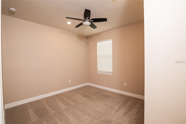 carpeted empty room with a textured ceiling and ceiling fan