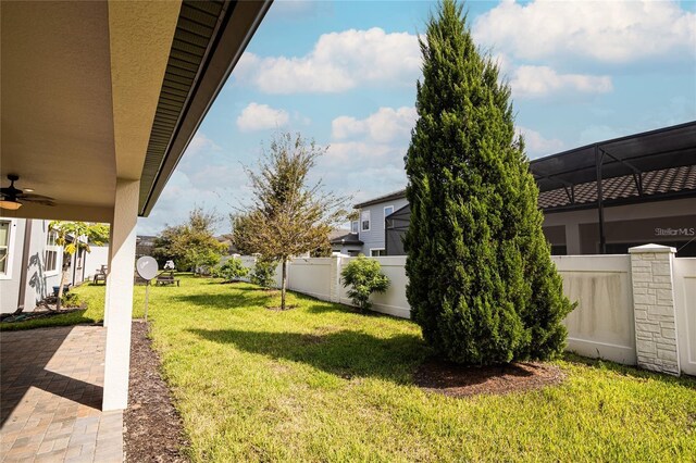 7845 Wandering Way, Orlando, FL 32836 - view of yard featuring ceiling fan and a patio