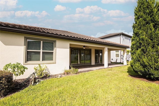 7845 Wandering Way, Orlando, FL 32836 - rear view of house with a ceiling fan, a yard, a patio area, and stucco siding