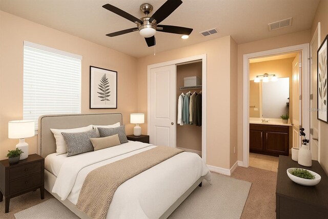 7845 Wandering Way, Orlando, FL 32836 - bedroom with light carpet, a closet, baseboards, ceiling fan, and ensuite bath