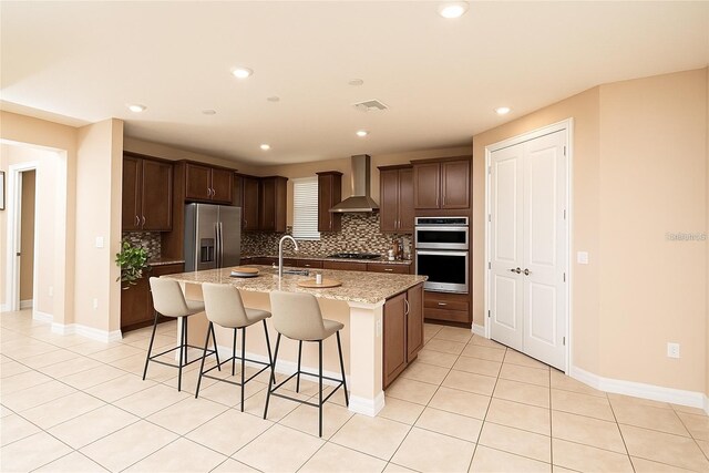 7845 Wandering Way, Orlando, FL 32836 - kitchen featuring appliances with stainless steel finishes, wall chimney exhaust hood, backsplash, a sink, and recessed lighting