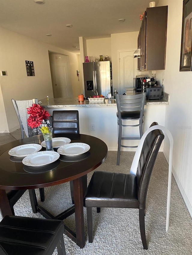 view of carpeted dining space