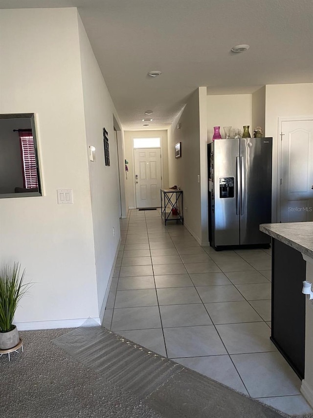 hall with light tile patterned floors