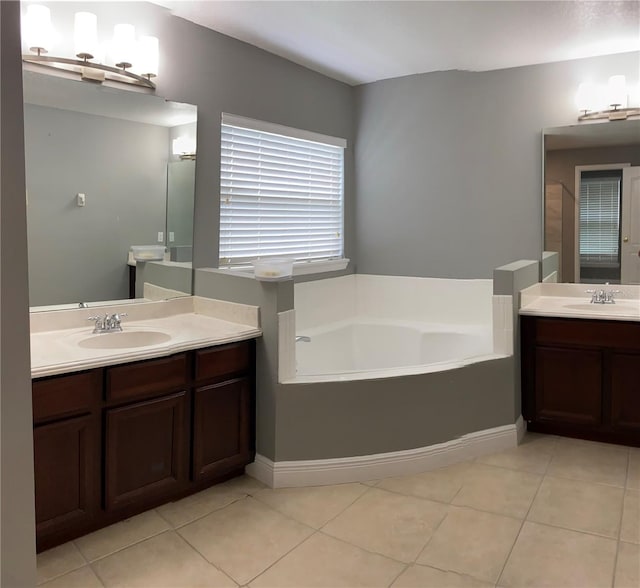 bathroom featuring a bath, tile patterned floors, and vanity