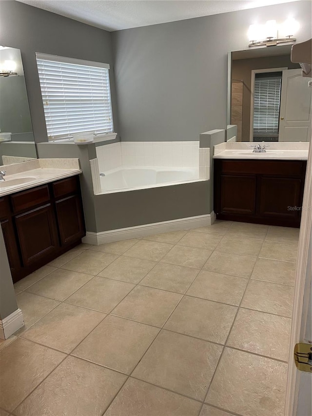 bathroom featuring a bathtub, vanity, and tile patterned floors