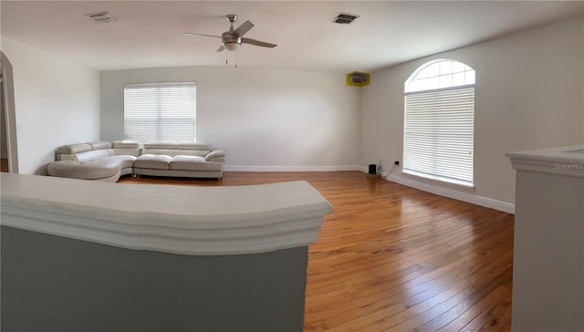 living room with ceiling fan and light hardwood / wood-style flooring