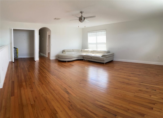 unfurnished living room featuring dark hardwood / wood-style floors and ceiling fan