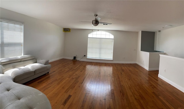 unfurnished living room with ceiling fan and dark hardwood / wood-style floors