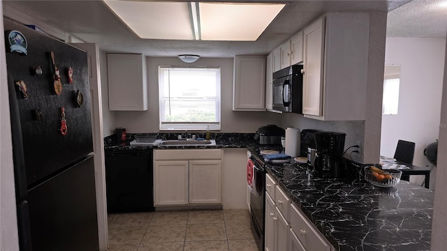 kitchen featuring white cabinetry, a textured ceiling, black appliances, and sink