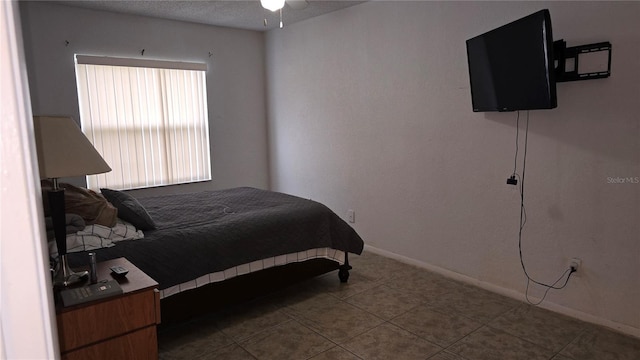 bedroom featuring tile patterned floors and a textured ceiling