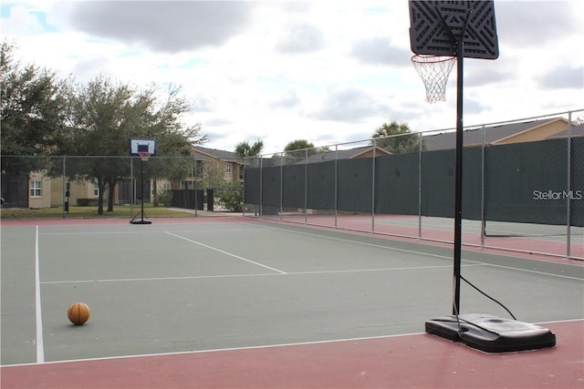 view of tennis court with basketball hoop