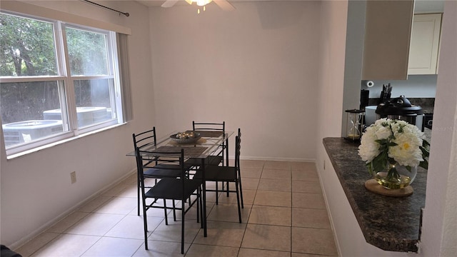 dining space with ceiling fan and light tile patterned flooring