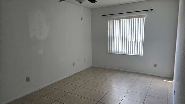 spare room with light tile patterned floors and ceiling fan