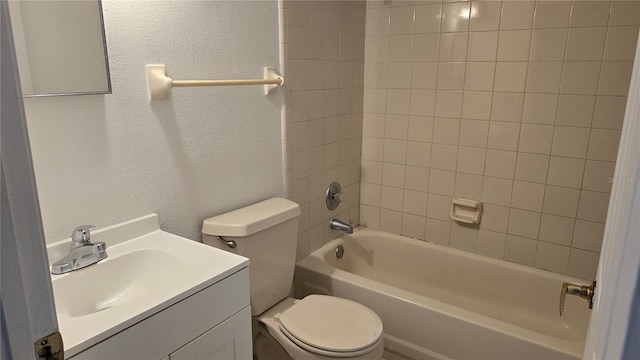 full bathroom with vanity, tiled shower / bath, and toilet