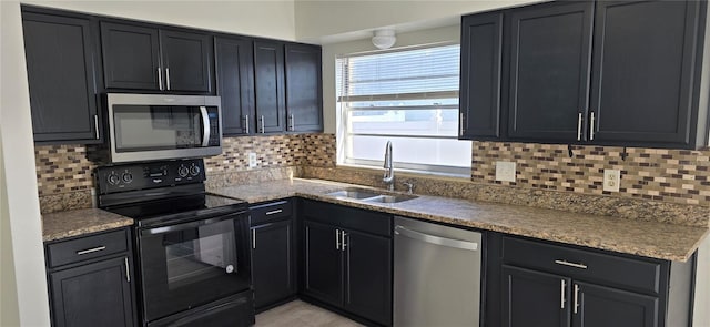 kitchen featuring tasteful backsplash, sink, stainless steel appliances, and dark stone countertops