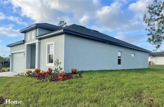 view of side of property featuring a garage and a yard