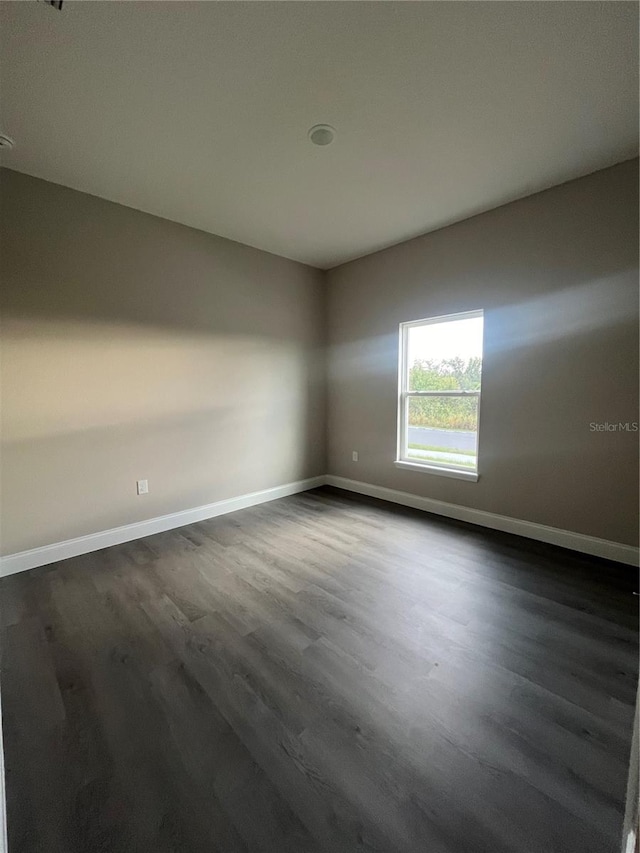 empty room featuring dark hardwood / wood-style flooring