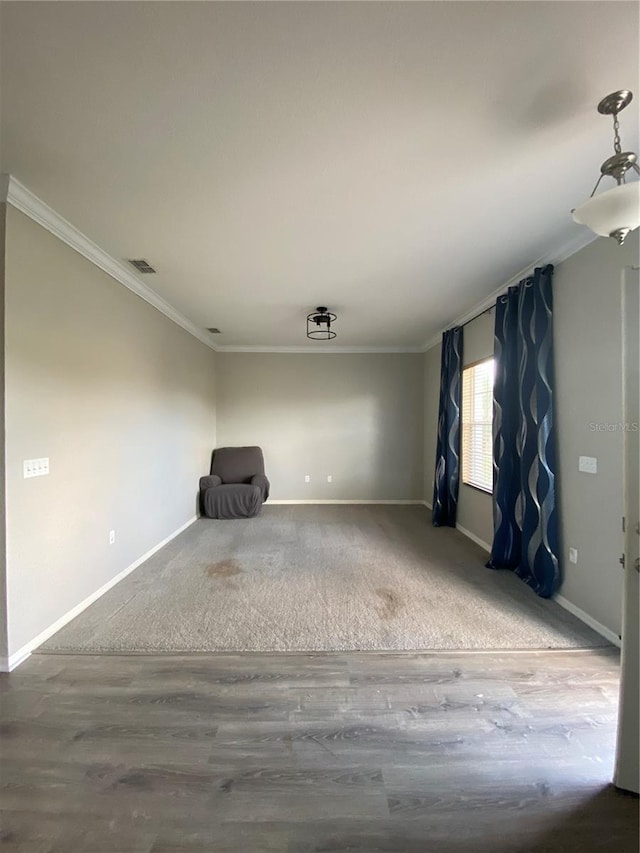 unfurnished room with hardwood / wood-style floors and crown molding