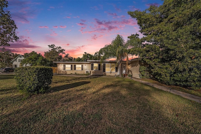 ranch-style house with a yard