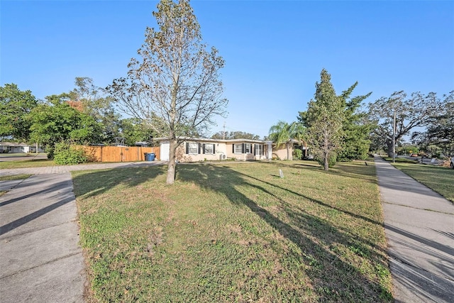 ranch-style home with a front yard