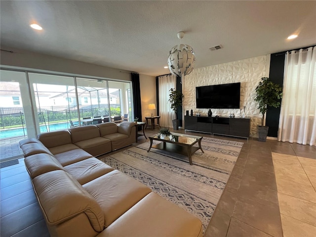 living room featuring a textured ceiling and tile patterned flooring