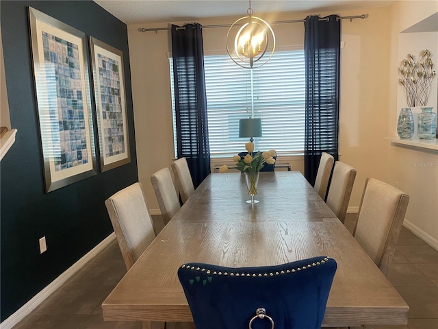 tiled dining area featuring a chandelier