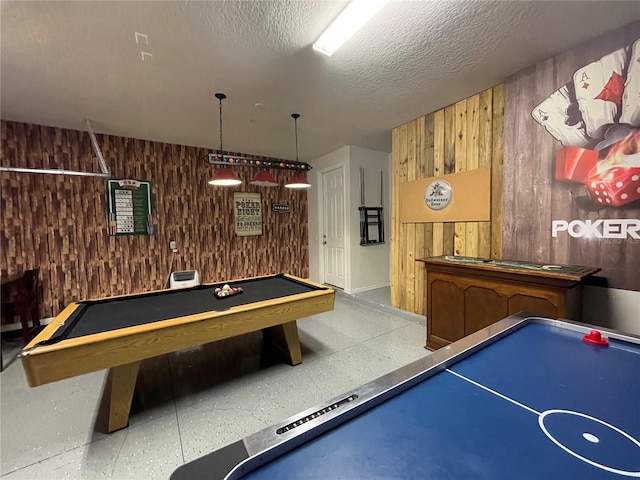 game room featuring wood walls, a textured ceiling, and billiards