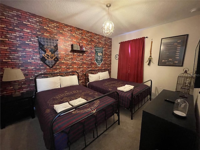 carpeted bedroom featuring a textured ceiling, a notable chandelier, and brick wall